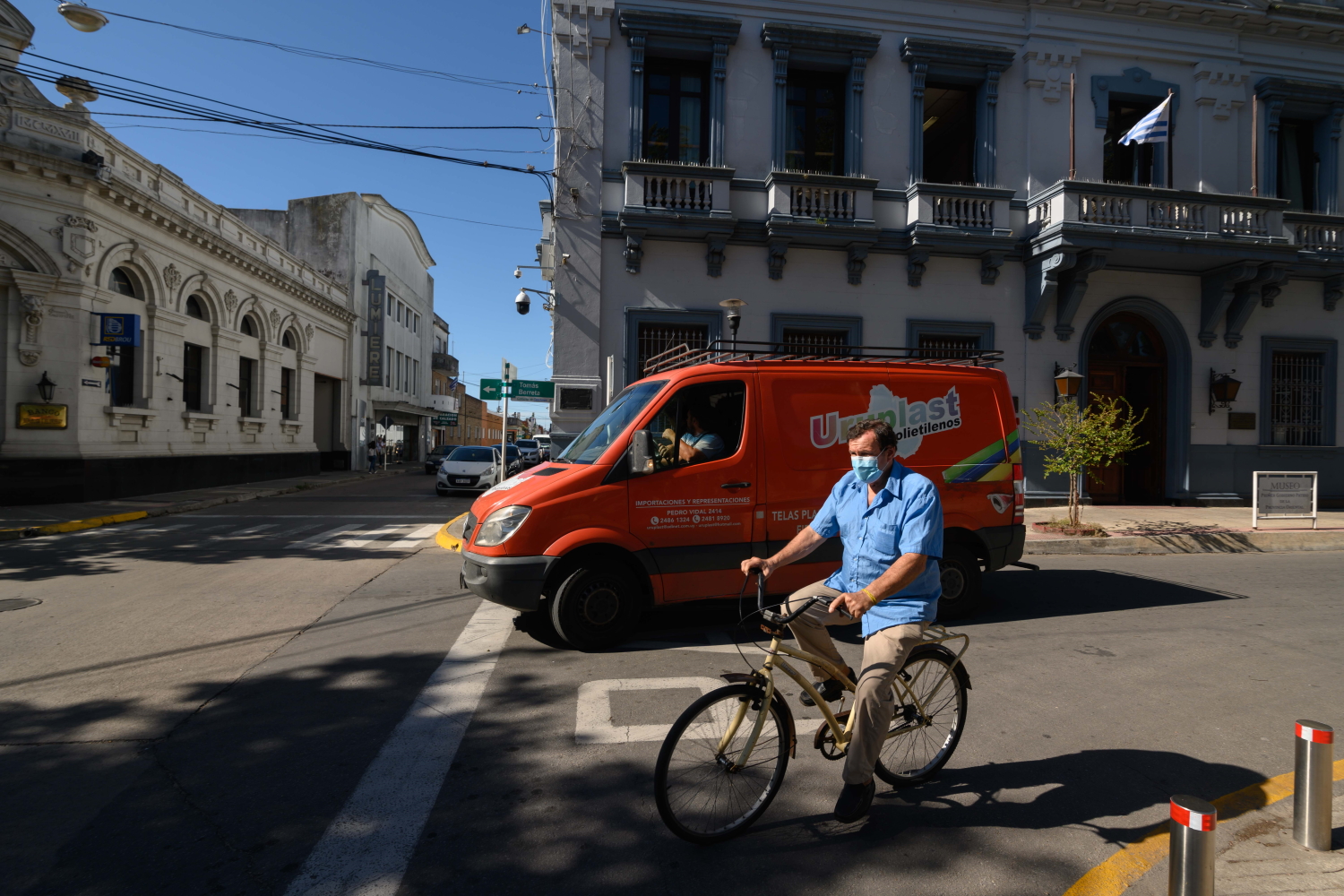 Hombre con tapabocas anda en bicicleta por la ciudad de Canelones.